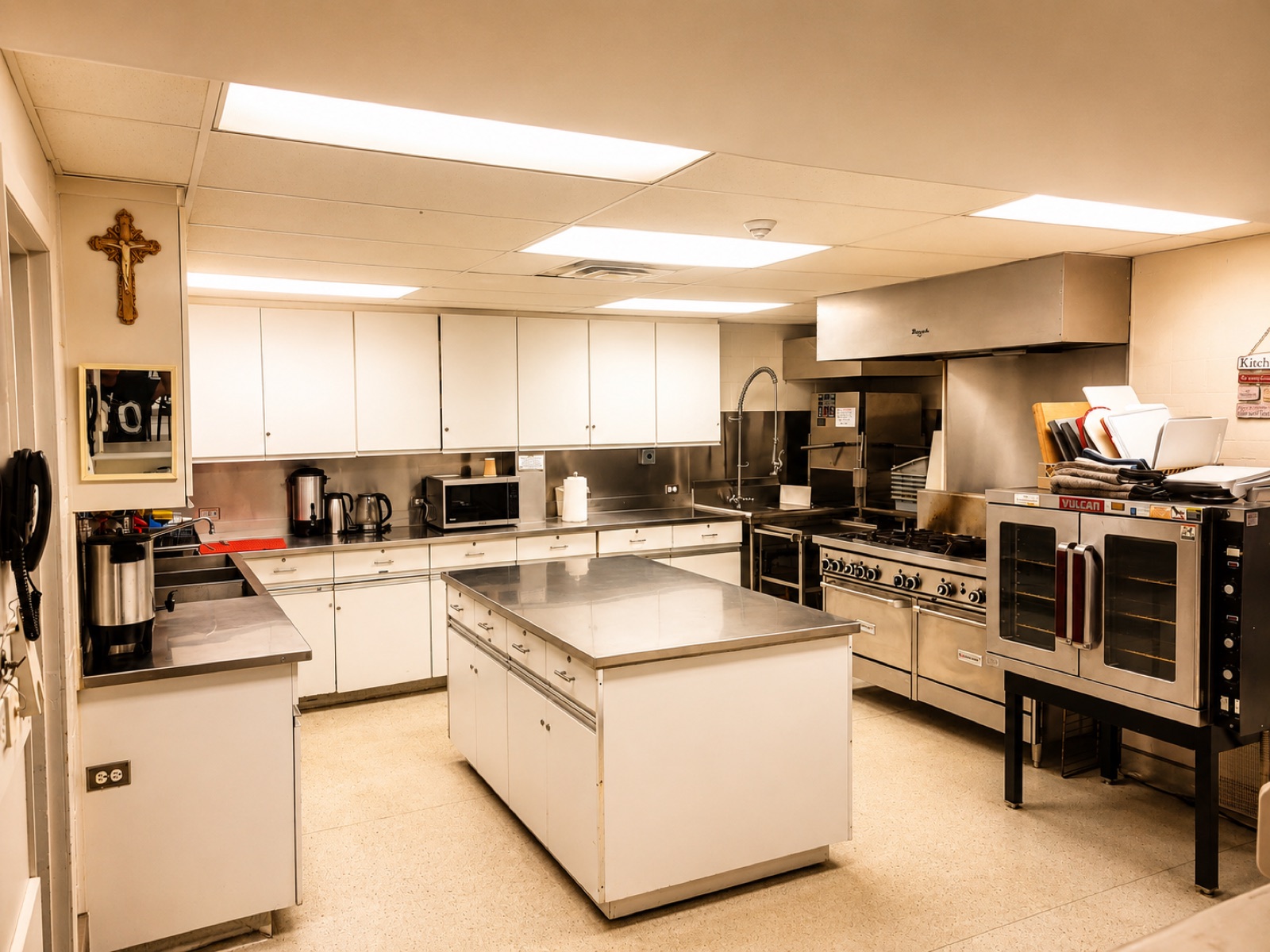 Commercial kitchen with gas ranges, convection oven and stainless prep counters